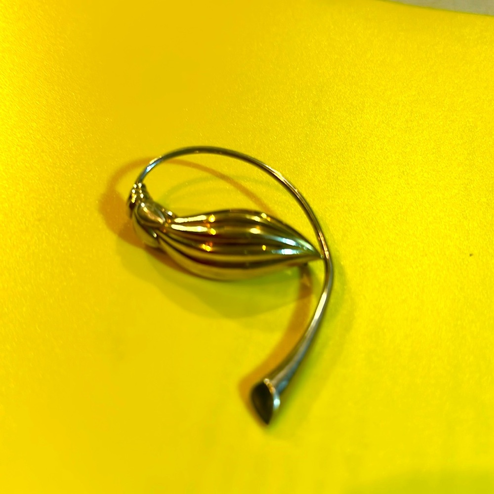 Silver with gold tint, handmade brooch stamped S 925 The weight is .14 g.